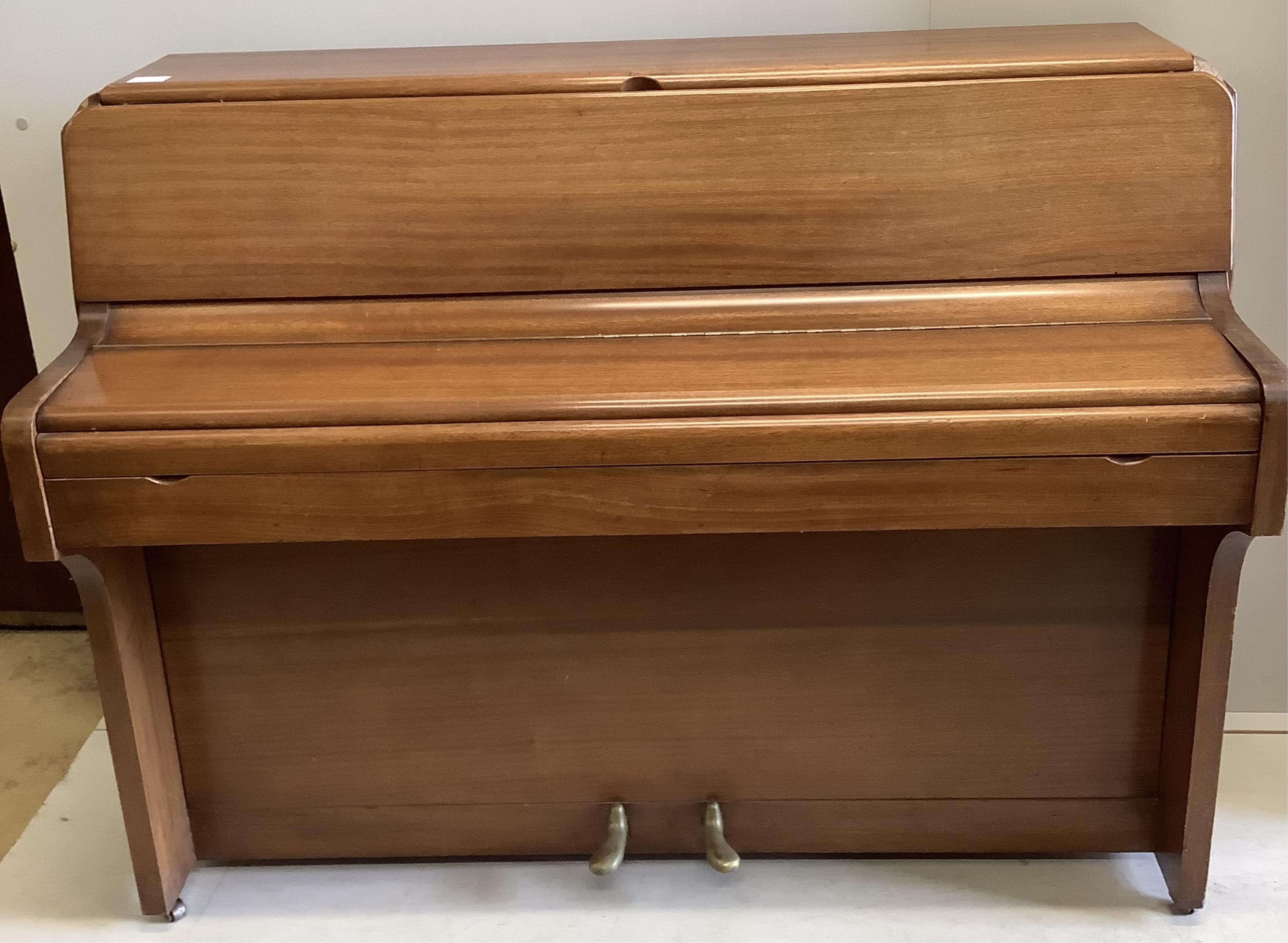 A 1960’s Royalette mahogany cased mini piano, with seven octaves, width 128cm, height 100cm. Condition - fair, one piece of timber detached but present